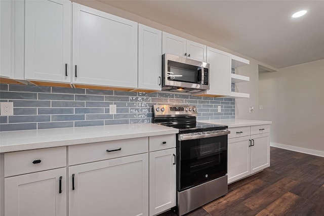 5032 Briscoe St, Houston, TX 77033 - kitchen with stainless steel appliances, open shelves, light countertops, dark wood finished floors, and recessed lighting