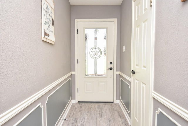 466 Emanuel Rd, Goodrich, TX 77335 - doorway with light wood finished floors and baseboards