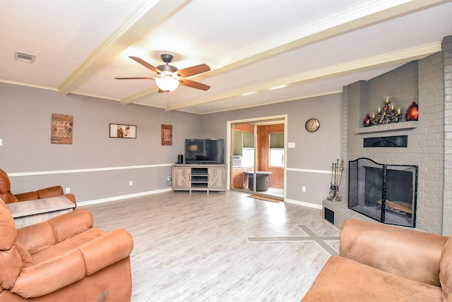 466 Emanuel Rd, Goodrich, TX 77335 - living area featuring a ceiling fan, a fireplace, wood finished floors, baseboards, and beam ceiling