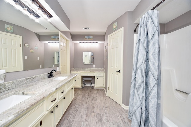 466 Emanuel Rd, Goodrich, TX 77335 - bathroom with double vanity, wood finished floors, and a shower with curtain