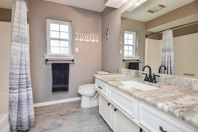 466 Emanuel Rd, Goodrich, TX 77335 - full bathroom with toilet, vanity, baseboards, wood finished floors, and curtained shower