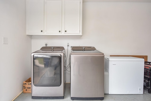466 Emanuel Rd, Goodrich, TX 77335 - washroom with cabinet space and washing machine and clothes dryer