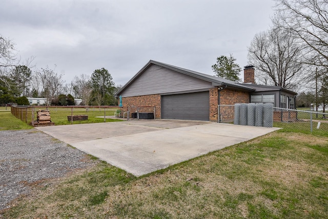466 Emanuel Rd, Goodrich, TX 77335 - view of side of home with brick siding, a chimney, driveway, and a garage