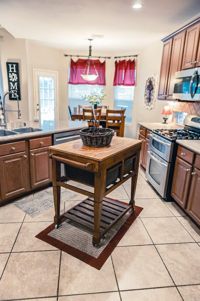 13926 Wessex Park Dr, Cypress, TX 77429 - kitchen featuring appliances with stainless steel finishes, healthy amount of natural light, light tile patterned floors, and recessed lighting