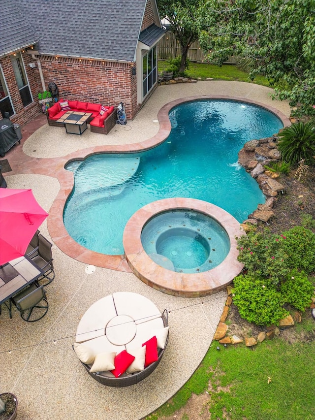 13926 Wessex Park Dr, Cypress, TX 77429 - view of swimming pool featuring a patio area, a pool with connected hot tub, and an outdoor living space