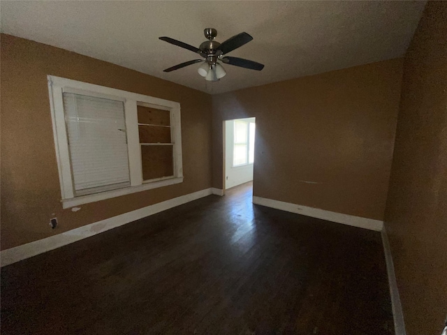3305 Pease St, Houston, TX 77003 - unfurnished room featuring baseboards, ceiling fan, and dark wood-style floors