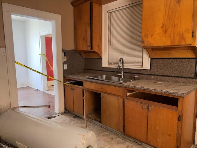 3305 Pease St, Houston, TX 77003 - kitchen with a sink, tasteful backsplash, dark countertops, and brown cabinets