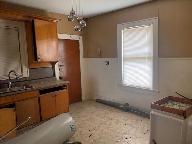 3305 Pease St, Houston, TX 77003 - kitchen with a sink, brown cabinets, and dark countertops