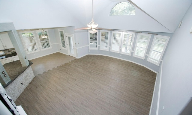 15915 Angler Bend Dr, Houston, TX 77044 - unfurnished living room with high vaulted ceiling, ceiling fan, wood finished floors, and plenty of natural light