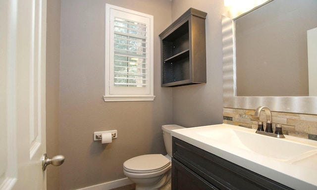 15915 Angler Bend Dr, Houston, TX 77044 - bathroom featuring toilet, vanity, tasteful backsplash, and baseboards