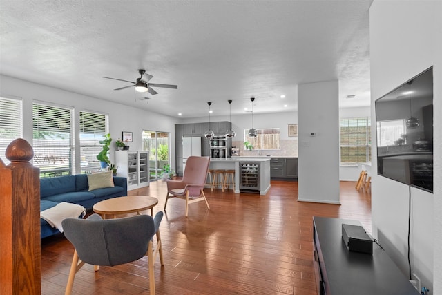 21519 Canyon Terrace Ln, Katy, TX 77450 - living area with beverage cooler, plenty of natural light, a ceiling fan, hardwood / wood-style flooring, and recessed lighting