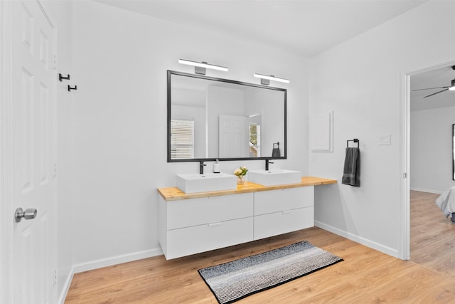 21519 Canyon Terrace Ln, Katy, TX 77450 - full bathroom with double vanity, wood finished floors, and baseboards