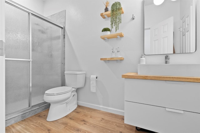 21519 Canyon Terrace Ln, Katy, TX 77450 - bathroom with toilet, vanity, a shower stall, baseboards, and wood finished floors