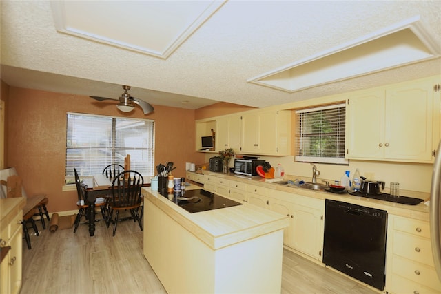 2236 River Oaks Dr, West Columbia, TX 77486 - kitchen with black appliances, a center island, light wood-type flooring, and a sink