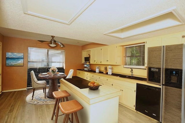 2236 River Oaks Dr, West Columbia, TX 77486 - kitchen with black appliances, a sink, light wood-style flooring, and plenty of natural light