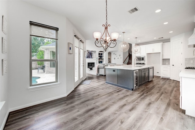 21622 Sabine Pass Ct, Katy, TX 77450 - kitchen featuring appliances with stainless steel finishes, a chandelier, recessed lighting, light countertops, and white cabinetry