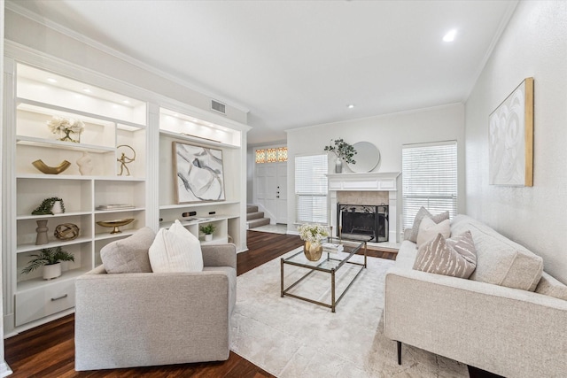 701 Bering Dr Unit 1702, Houston, TX 77057 - living area featuring wood finished floors, stairs, crown molding, and a tile fireplace