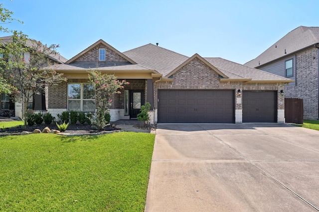 10315 Silver Shield Way, Tomball, TX 77375 - view of front facade with brick siding, a garage, driveway, a front yard, and roof with shingles