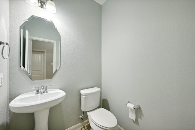 10315 Silver Shield Way, Tomball, TX 77375 - half bath featuring toilet, baseboards, and a sink