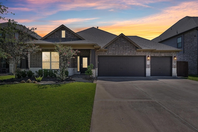 10315 Silver Shield Way, Tomball, TX 77375 - french country home featuring an attached garage, a front lawn, driveway, brick siding, and a shingled roof