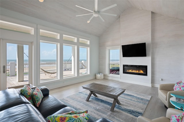 852 W Lazy Ln, Crystal Beach, TX 77650 - living room with high vaulted ceiling, a fireplace, a ceiling fan, and wood finished floors