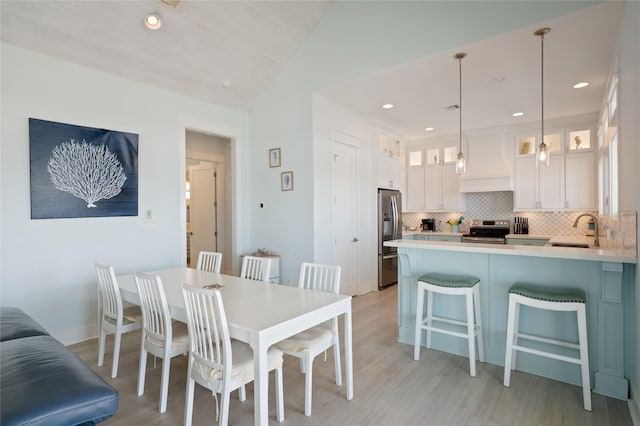 852 W Lazy Ln, Crystal Beach, TX 77650 - dining space with light wood-style flooring, vaulted ceiling, and recessed lighting