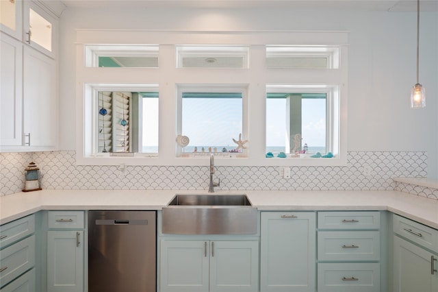 852 W Lazy Ln, Crystal Beach, TX 77650 - kitchen with stainless steel dishwasher, backsplash, light countertops, glass insert cabinets, and decorative light fixtures