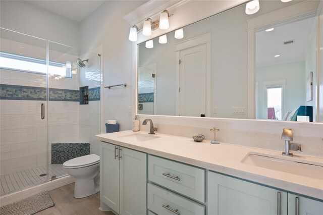 852 W Lazy Ln, Crystal Beach, TX 77650 - bathroom featuring double vanity, a stall shower, and wood finished floors