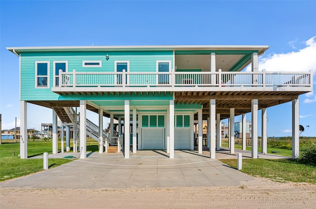 852 W Lazy Ln, Crystal Beach, TX 77650 - coastal home with a carport, a deck, concrete driveway, stairs, and a front yard