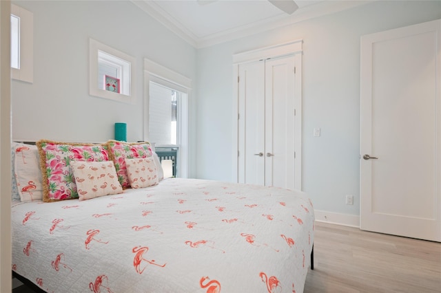 852 W Lazy Ln, Crystal Beach, TX 77650 - bedroom featuring wood finished floors, ornamental molding, a closet, and a ceiling fan