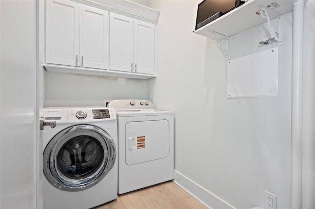 852 W Lazy Ln, Crystal Beach, TX 77650 - laundry area with washing machine and clothes dryer, cabinet space, and light wood-style flooring