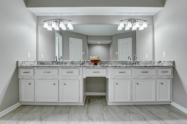 1406 Rustic Knolls Dr, Katy, TX 77450 - bathroom featuring double vanity, a chandelier, and baseboards