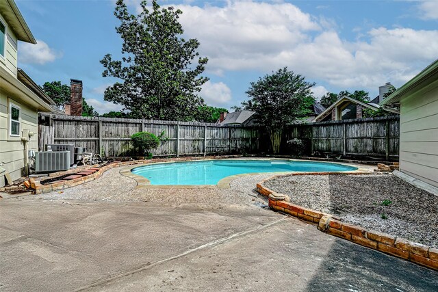 1406 Rustic Knolls Dr, Katy, TX 77450 - view of pool featuring central AC unit, a patio area, and a fenced backyard