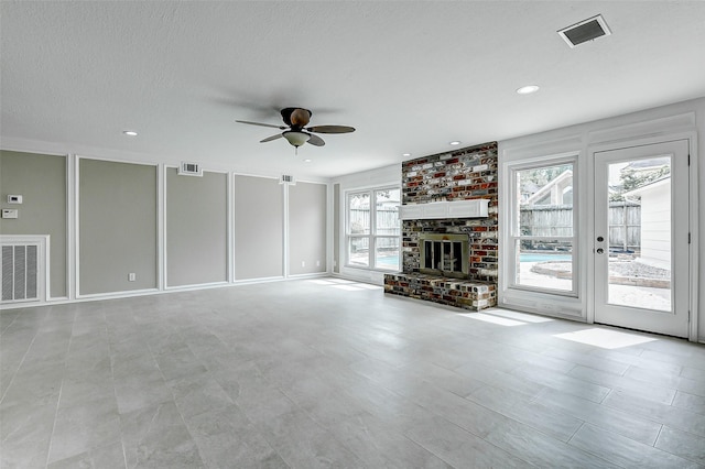 1406 Rustic Knolls Dr, Katy, TX 77450 - unfurnished living room featuring ceiling fan, a fireplace, and recessed lighting
