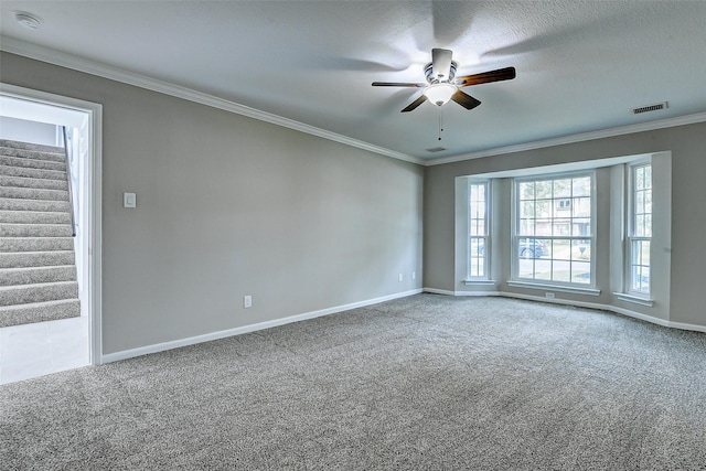 1406 Rustic Knolls Dr, Katy, TX 77450 - carpeted empty room featuring ceiling fan, baseboards, stairway, and ornamental molding