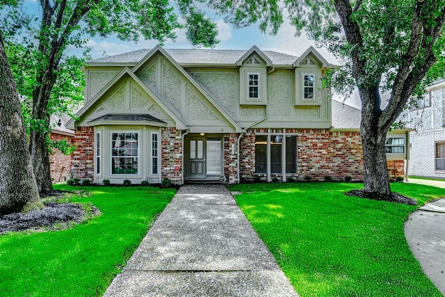 1406 Rustic Knolls Dr, Katy, TX 77450 - view of front facade with a front lawn, stucco siding, a shingled roof, and brick siding