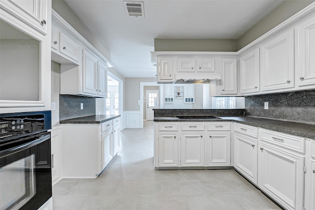 1406 Rustic Knolls Dr, Katy, TX 77450 - kitchen featuring black appliances, white cabinetry, and tasteful backsplash