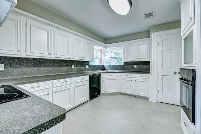 1406 Rustic Knolls Dr, Katy, TX 77450 - kitchen featuring black appliances, white cabinetry, a sink, and tasteful backsplash
