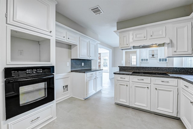 1406 Rustic Knolls Dr, Katy, TX 77450 - kitchen with black appliances, white cabinets, and dark stone countertops