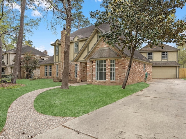 17627 Terrawren Ln, Spring, TX 77379 - view of front of house featuring driveway, a front lawn, a chimney, and brick siding