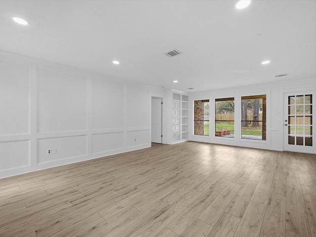 17627 Terrawren Ln, Spring, TX 77379 - unfurnished living room featuring a decorative wall, recessed lighting, light wood-style flooring, built in features, and ornamental molding