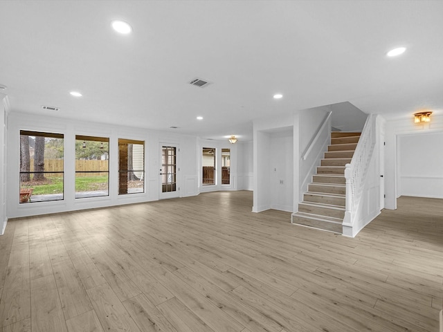 17627 Terrawren Ln, Spring, TX 77379 - unfurnished living room featuring stairs, light wood finished floors, and recessed lighting