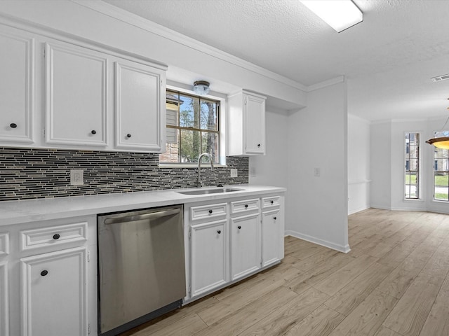 17627 Terrawren Ln, Spring, TX 77379 - kitchen featuring dishwasher, a sink, decorative backsplash, ornamental molding, and light countertops