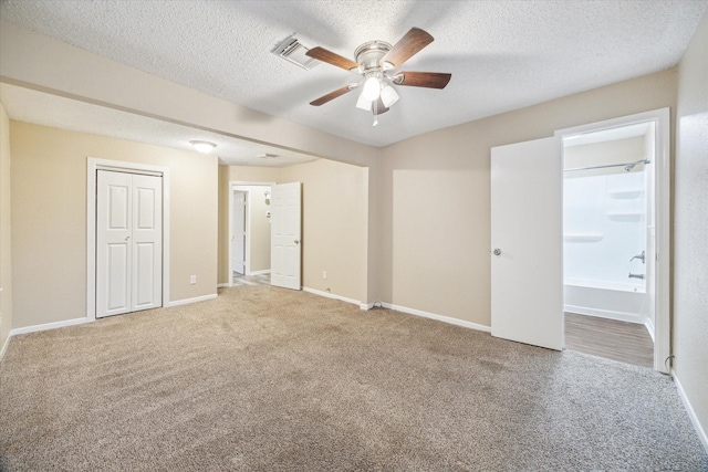 4446 Castor St, Houston, TX 77022 - unfurnished bedroom featuring carpet, baseboards, a textured ceiling, connected bathroom, and ceiling fan