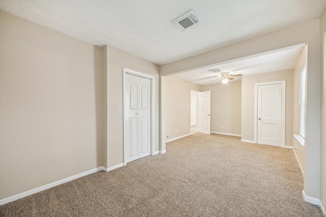 4446 Castor St, Houston, TX 77022 - carpeted empty room with baseboards, a ceiling fan, and a textured ceiling