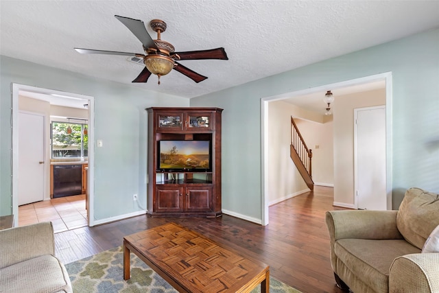 3734 Glade Forest Dr, Kingwood, TX 77339 - living area featuring hardwood / wood-style floors, stairs, a ceiling fan, baseboards, and a textured ceiling