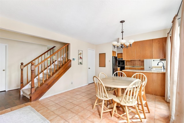 3734 Glade Forest Dr, Kingwood, TX 77339 - dining space with a chandelier, stairs, and light tile patterned flooring