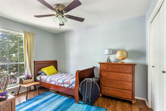 3734 Glade Forest Dr, Kingwood, TX 77339 - bedroom with a closet, dark wood finished floors, a ceiling fan, and baseboards