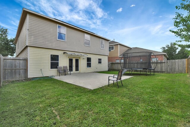 6706 Lindale Manor Ct, Spring, TX 77379 - rear view of property with a trampoline, french doors, a patio area, and a fenced backyard