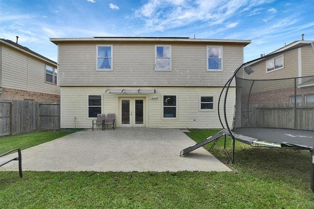 6706 Lindale Manor Ct, Spring, TX 77379 - back of property featuring a trampoline, french doors, a patio area, and a fenced backyard